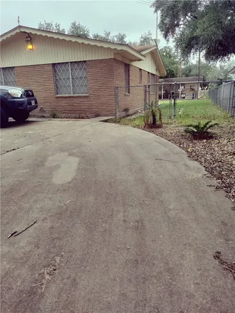 a view of a house with a yard and garage