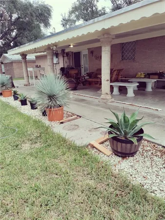 a view of a porch with furniture and a yard