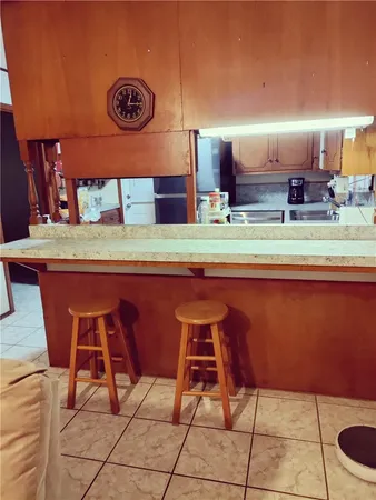 a room with table chairs and a clock