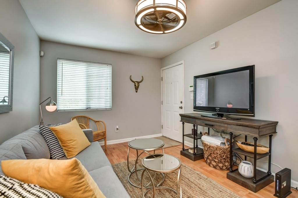 210 Sampson Street Northeast, Unit 5 Atlanta, GA 30312 - Photo 4 of 33 a living room with furniture a rug and a flat screen tv