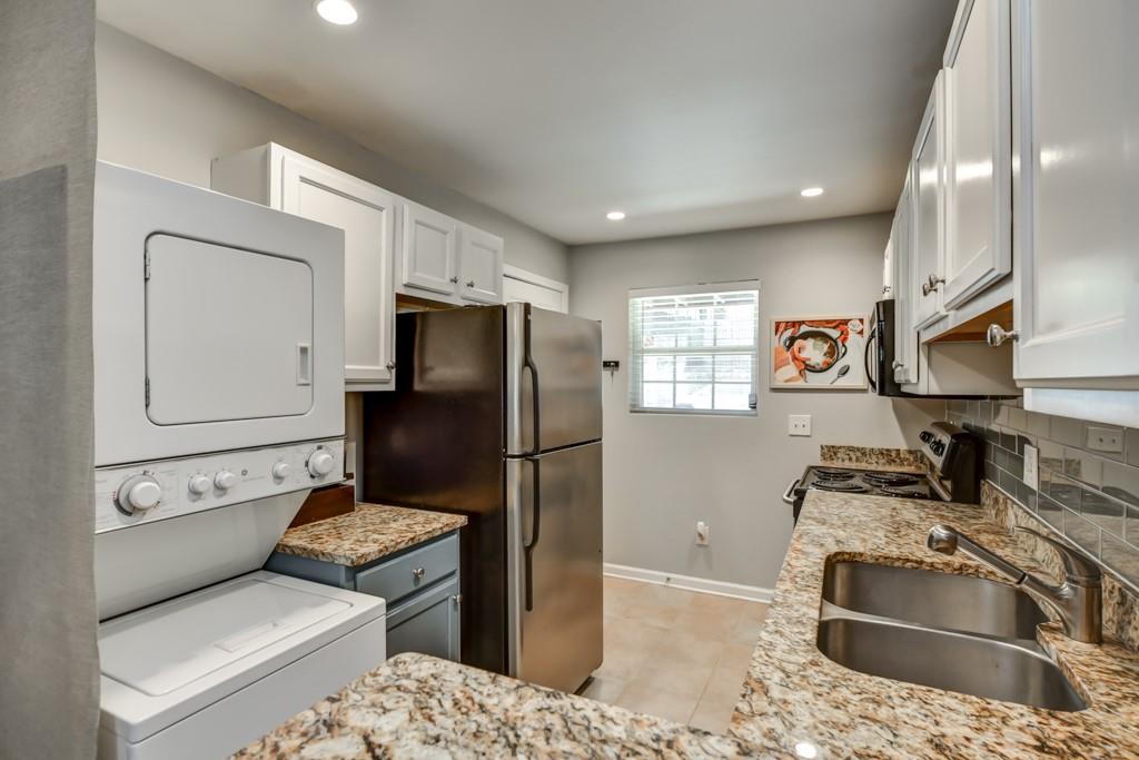 210 Sampson Street Northeast, Unit 5 Atlanta, GA 30312 - Photo 9 of 33 a kitchen with stainless steel appliances granite countertop a refrigerator sink and stove
