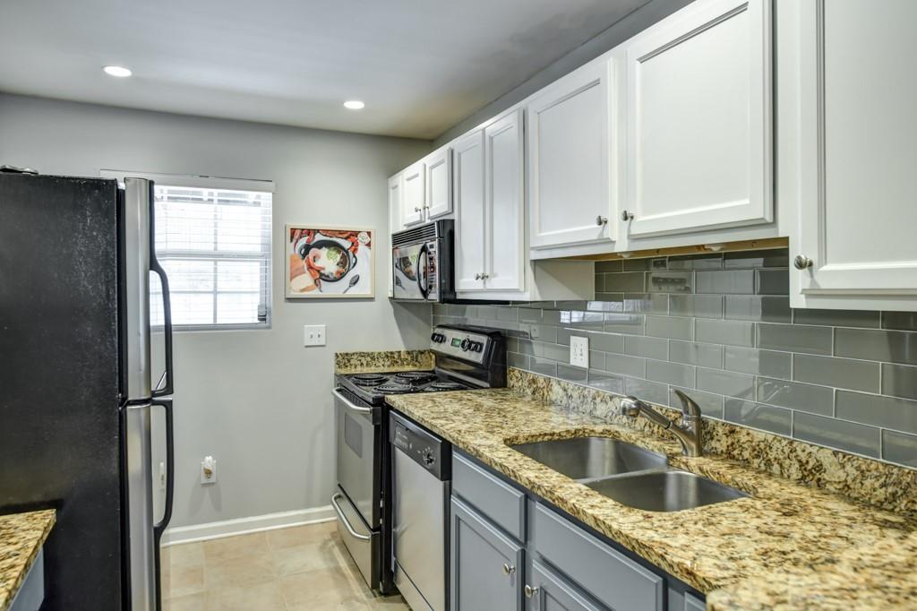 210 Sampson Street Northeast, Unit 5 Atlanta, GA 30312 - Photo 10 of 33 a kitchen with stainless steel appliances granite countertop a sink stove and refrigerator