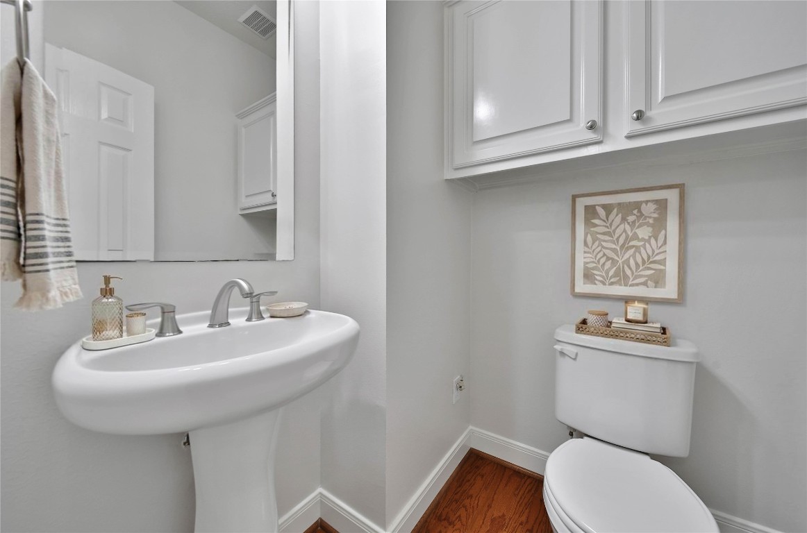 19 Millwright Place The Woodlands, TX 77382 - Photo 19 of 45 A first floor half bath is conveniently located for guests with convenient storage cabinets for all the essentials.