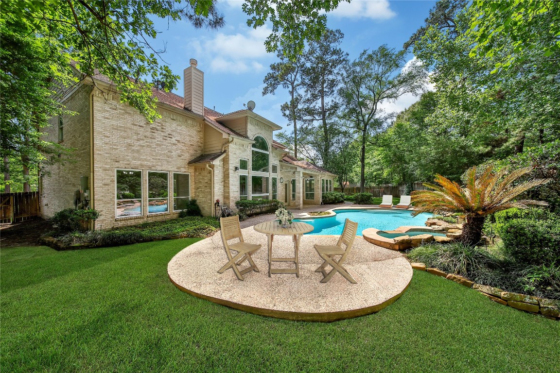 19 Millwright Place The Woodlands, TX 77382 - Photo 29 of 45 The pool deck offers space to lounge by the pool or a space to enjoy a snack break during playtime.