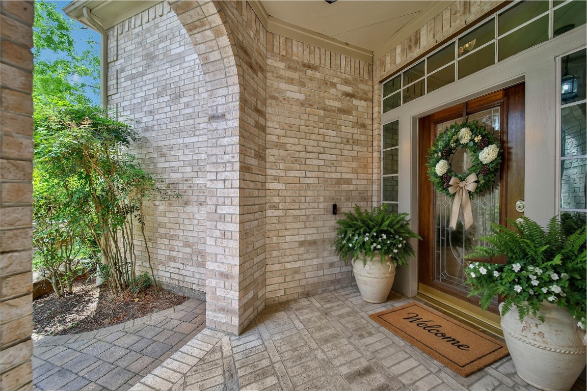 19 Millwright Place The Woodlands, TX 77382 - Photo 6 of 45 The oversized front porch with a wood and glass front door and smart doorbell is welcoming for you and your guests.