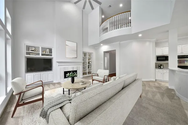 a view of a dining room and livingroom with furniture wooden floor a chandelier