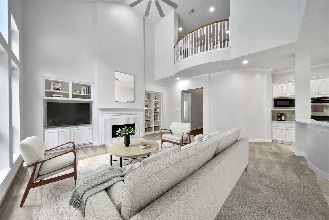 19 Millwright Place The Woodlands, TX 77382 - Photo 7 of 45 The two-story family room with custom built-ins, a gaslog fireplace, and tranquil views of your backyard is a space you will love.
