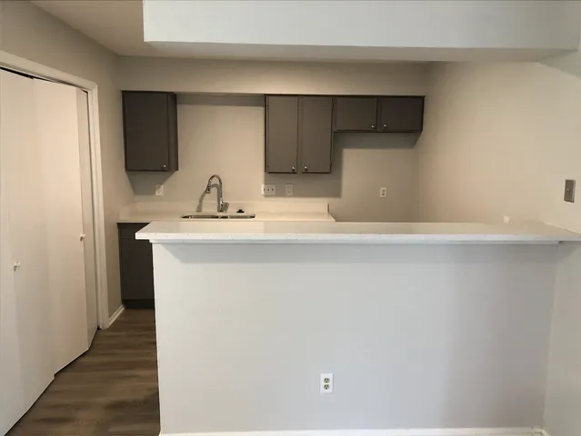 a close view of a sink and a refrigerator in a kitchen