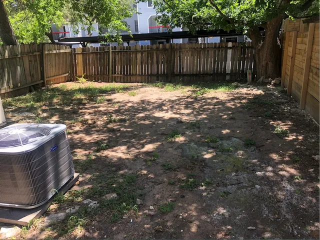a backyard of a house with green landscape