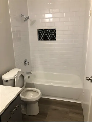 a bathroom with a toilet a sink and bathtub