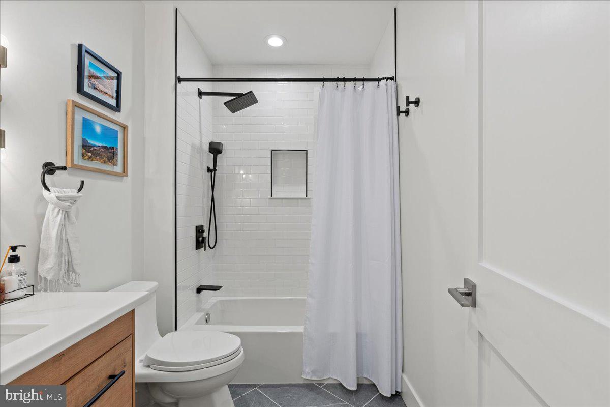 3424 Toone Street Baltimore, MD 21224 - Photo 18 of 87 a bathroom with a granite countertop toilet a sink and a bathtub