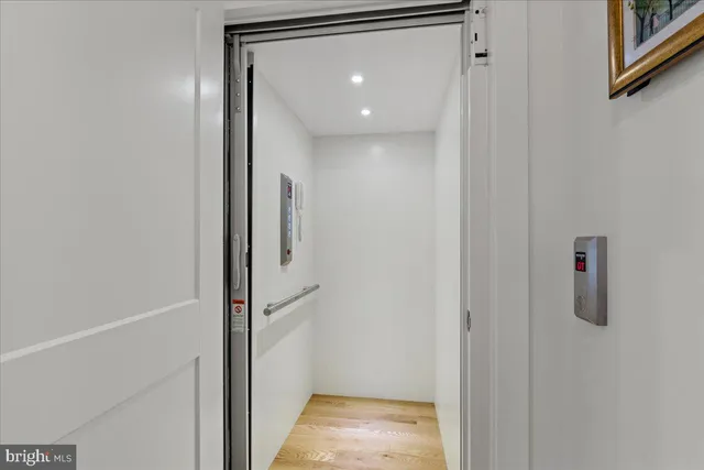 a bedroom with a large bed and a flat tv screen on dresser