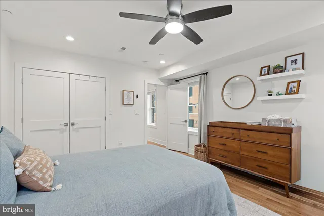a large white kitchen with a lot of counter space and a sink