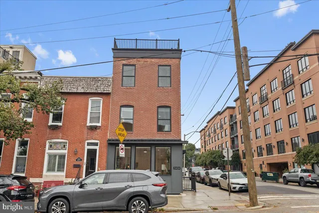 a view of a street that has couple of cars parked on the road