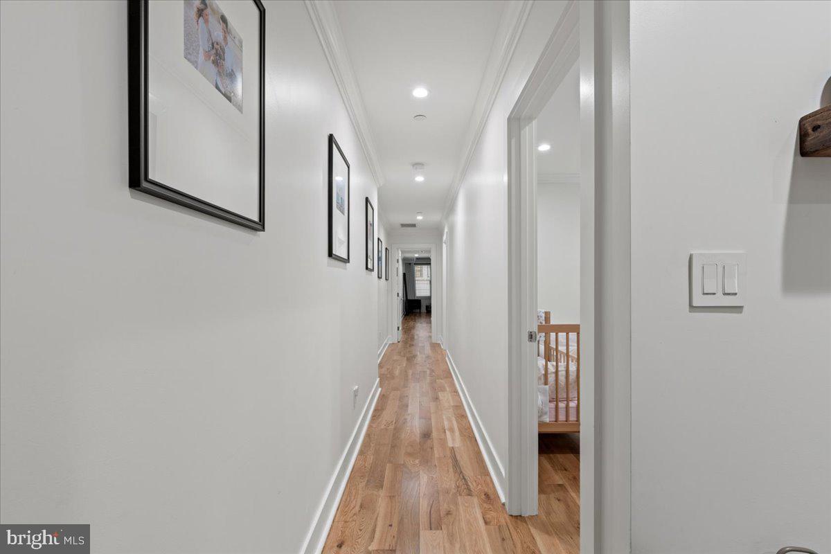 3424 Toone Street Baltimore, MD 21224 - Photo 34 of 87 a view of a hallway with paintings on the wall