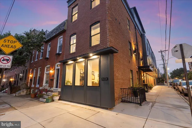a front view of a house with a potted plant
