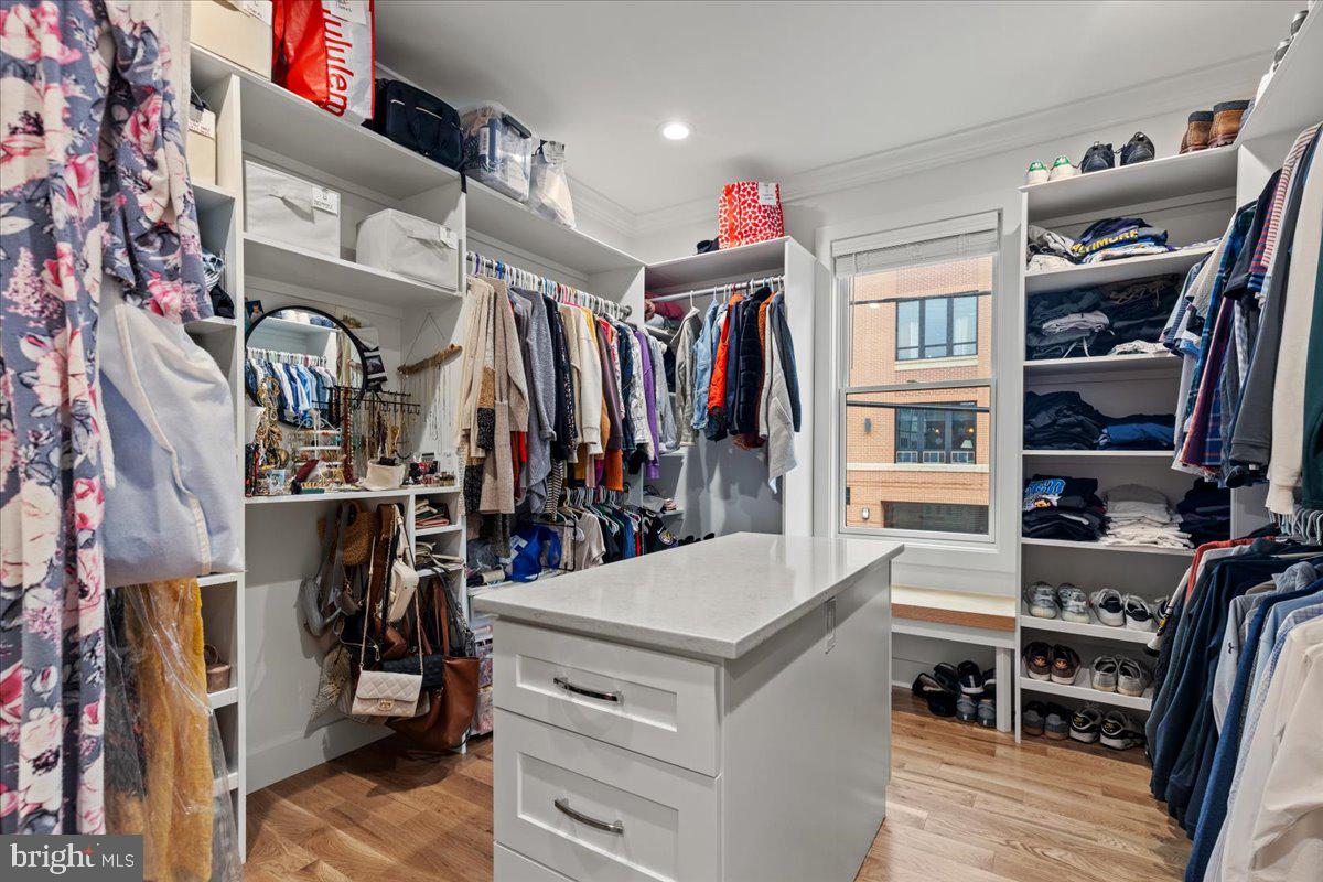 3424 Toone Street Baltimore, MD 21224 - Photo 43 of 87 a view of walk in closet with clothes and shoes