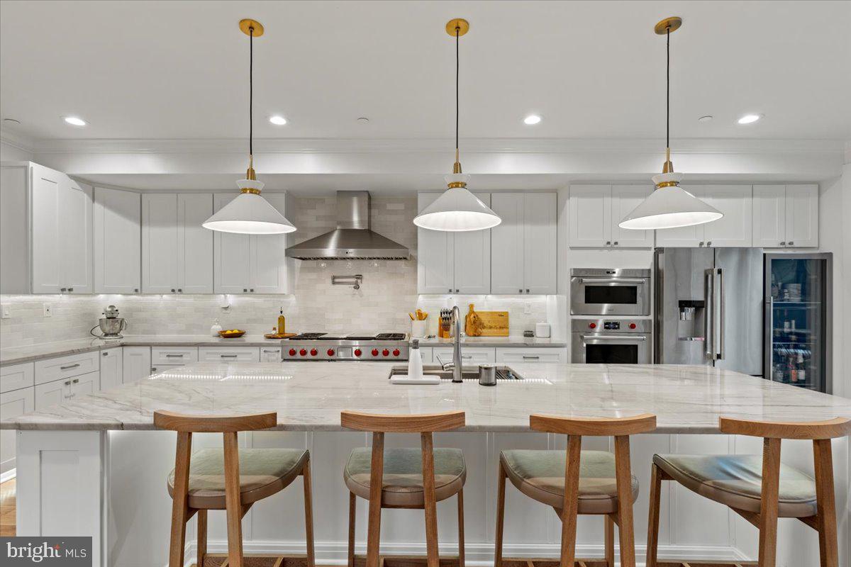 3424 Toone Street Baltimore, MD 21224 - Photo 59 of 87 a kitchen with stainless steel appliances kitchen island granite countertop a dining table chairs sink and cabinets