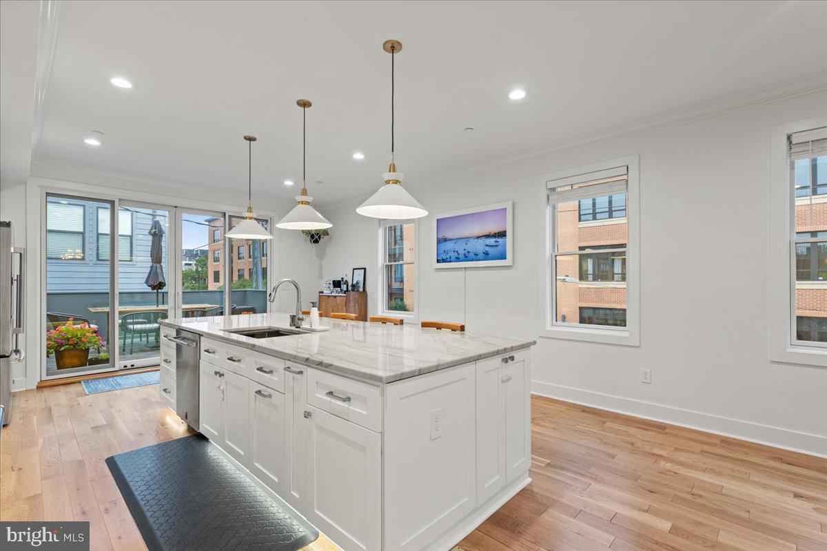 3424 Toone Street Baltimore, MD 21224 - Photo 60 of 87 a view of a kitchen counter space with wooden floor and floors