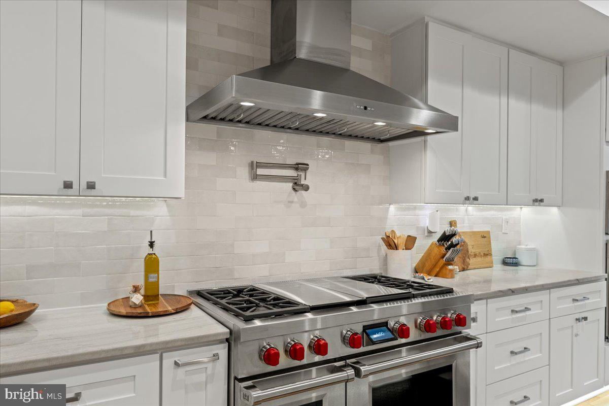 3424 Toone Street Baltimore, MD 21224 - Photo 61 of 87 a kitchen with stainless steel appliances granite countertop a stove and a white wooden cabinets