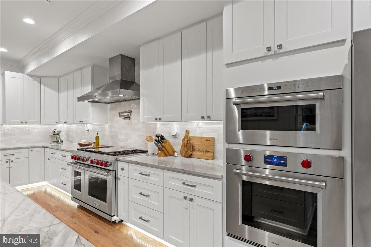 3424 Toone Street Baltimore, MD 21224 - Photo 62 of 87 a kitchen with stainless steel appliances granite countertop a stove a microwave and cabinets
