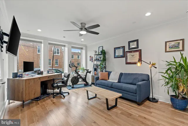 a bathroom with a granite countertop sink a mirror a toilet and a shower