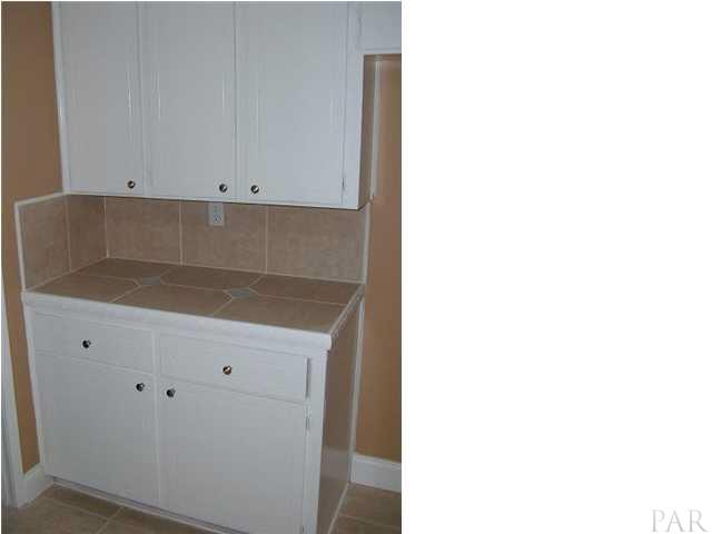 10209 Gallows Road Cantonment, FL 32533 - Photo 7 of 22 Another set of cabinets in the kitchen for additional space..