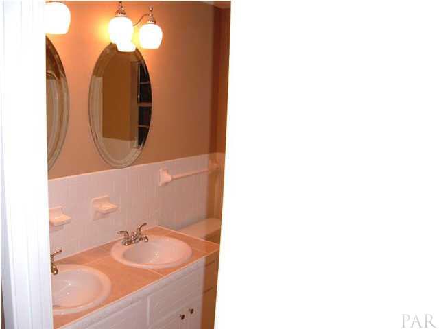 10209 Gallows Road Cantonment, FL 32533 - Photo 9 of 22 Guest bath looks incredible complete with dual sinks and vanities but only one tub and shower.