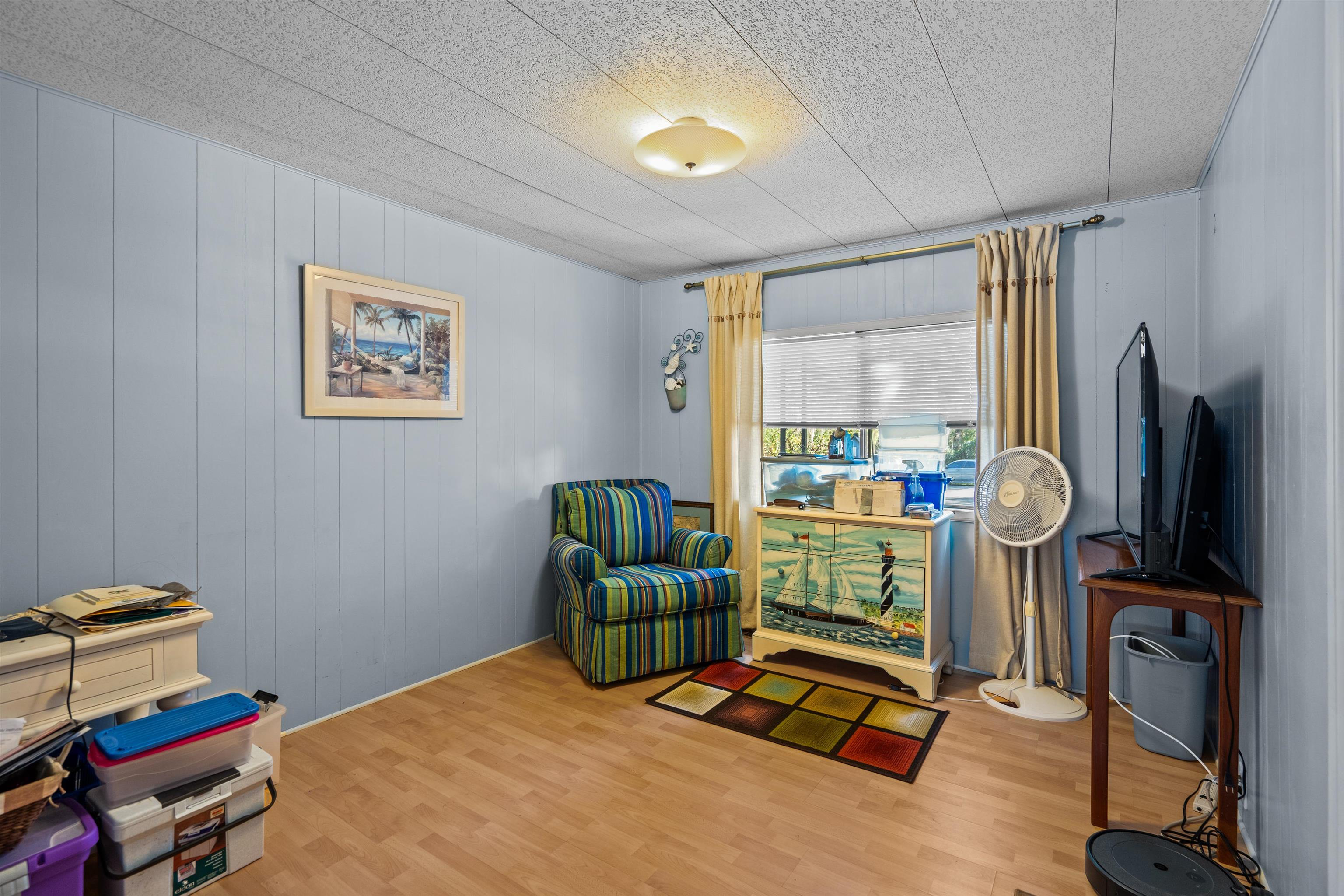 3979 Oak Terrace Road St. Augustine, FL 32086 - Photo 15 of 36 a bedroom with furniture and a flat screen tv