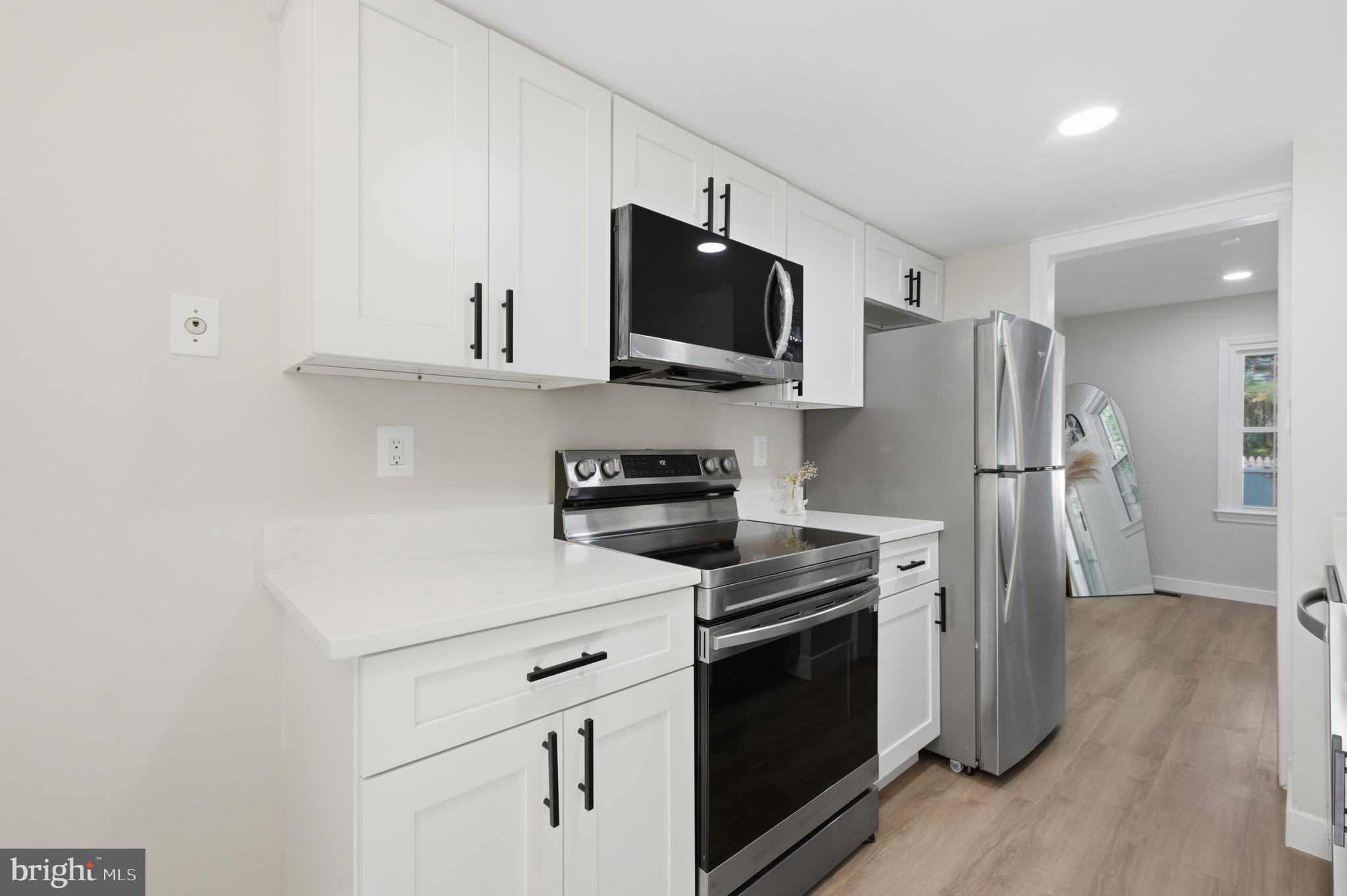 8575 Tyrolean Way Springfield, VA 22153 - Photo 9 of 29 a kitchen with stainless steel appliances a refrigerator stove and microwave