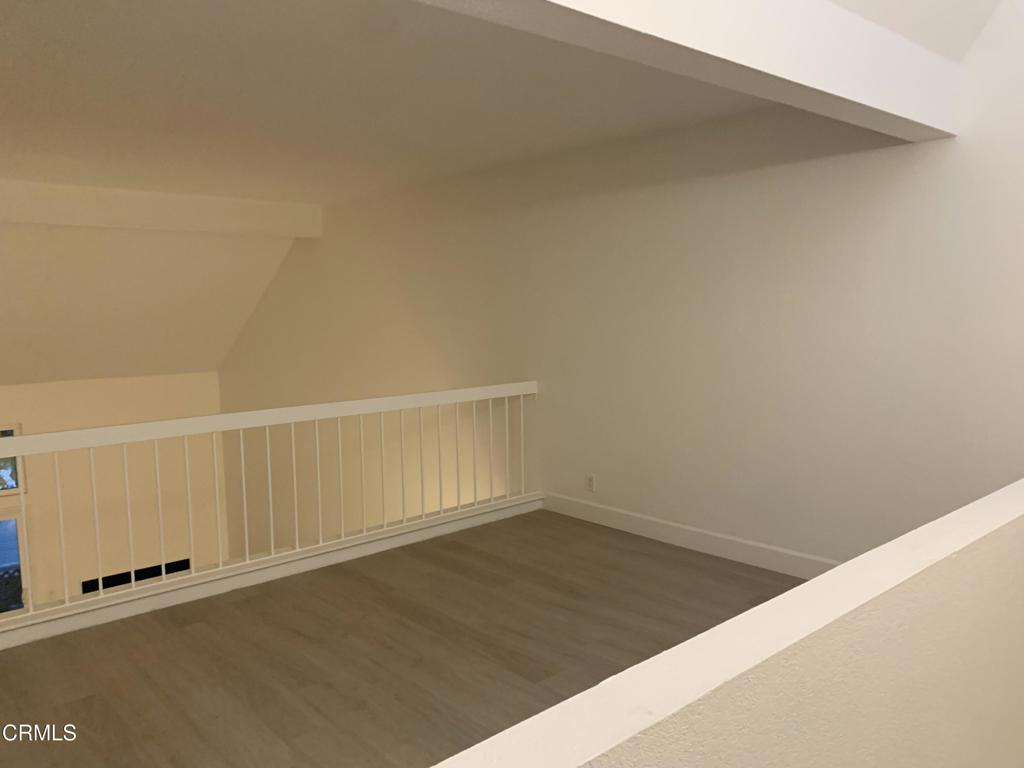 639 Springbrook North, Unit 48 Irvine, CA 92614 - Photo 11 of 12 an empty room with a wooden floor