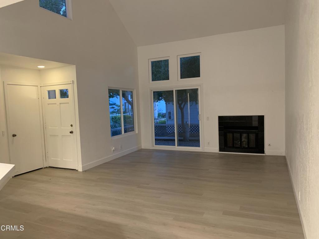 639 Springbrook North, Unit 48 Irvine, CA 92614 - Photo 2 of 12 a view of an empty room with kitchen and a window