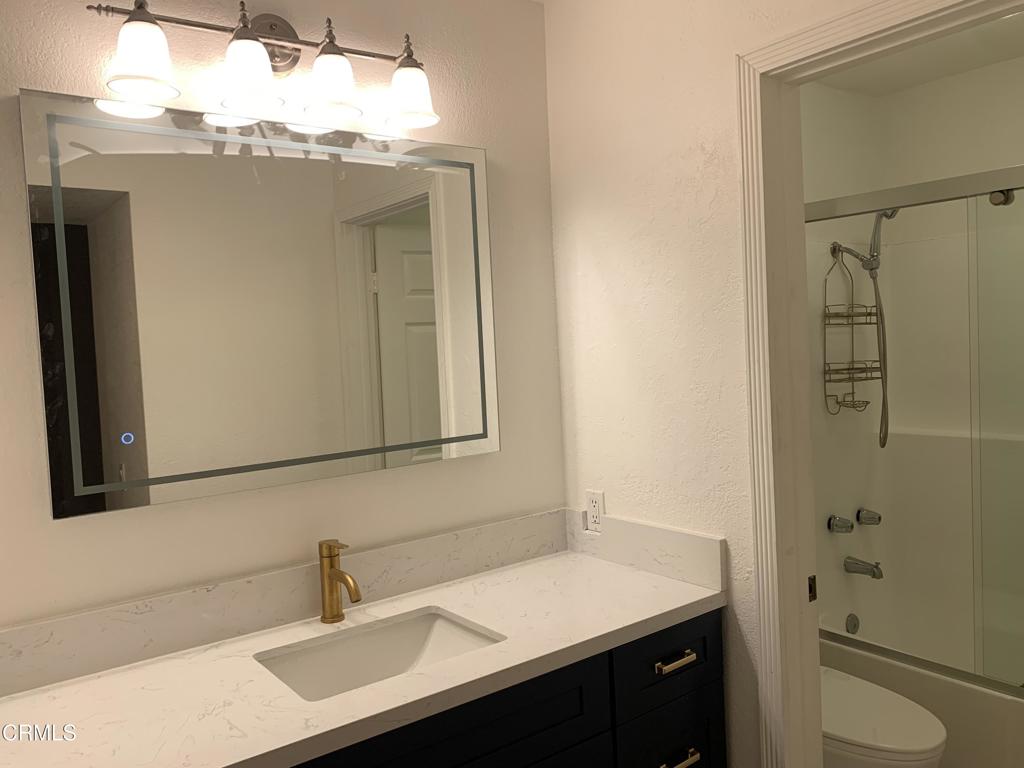 639 Springbrook North, Unit 48 Irvine, CA 92614 - Photo 7 of 12 a bathroom with a sink and a mirror