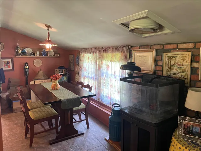 a dining room with furniture window and outside view