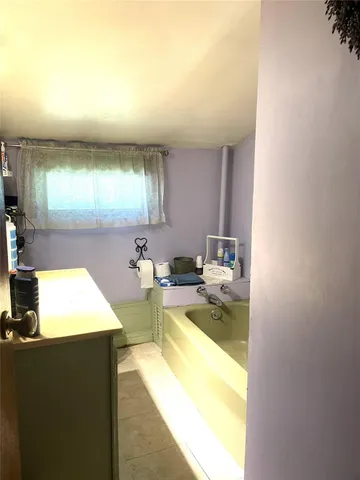 a bedroom with a bed and large windows