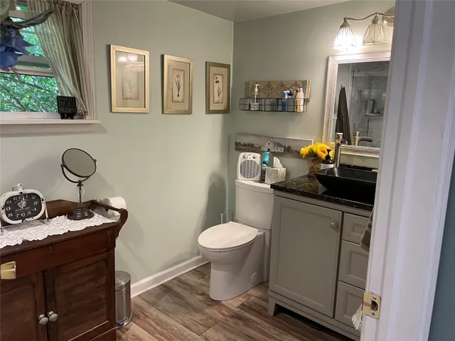 a bathroom with a sink toilet and a mirror