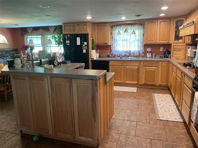 a kitchen with stainless steel appliances granite countertop a stove and a refrigerator