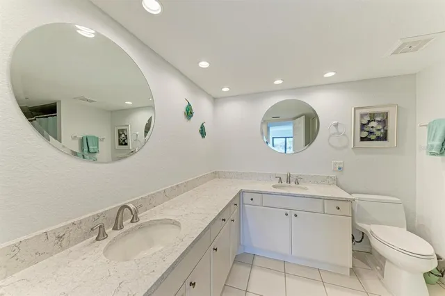 a bathroom with a granite countertop sink mirror and vanity