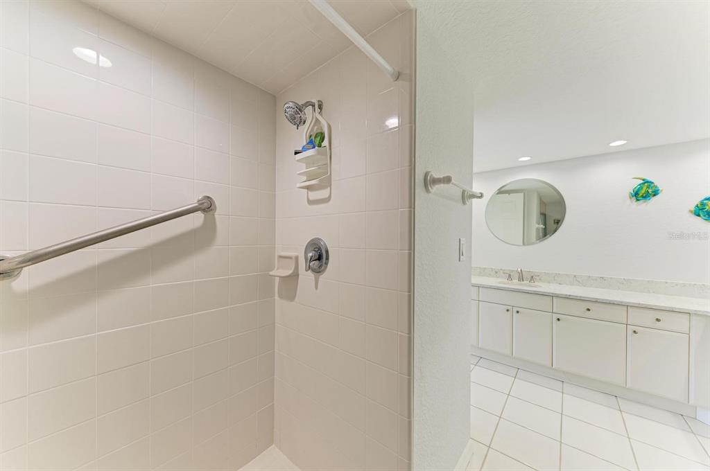 601 Shreve Street, Unit 46A Punta Gorda, FL 33950 - Photo 15 of 23 a bathroom with a granite countertop sink a mirror and shower