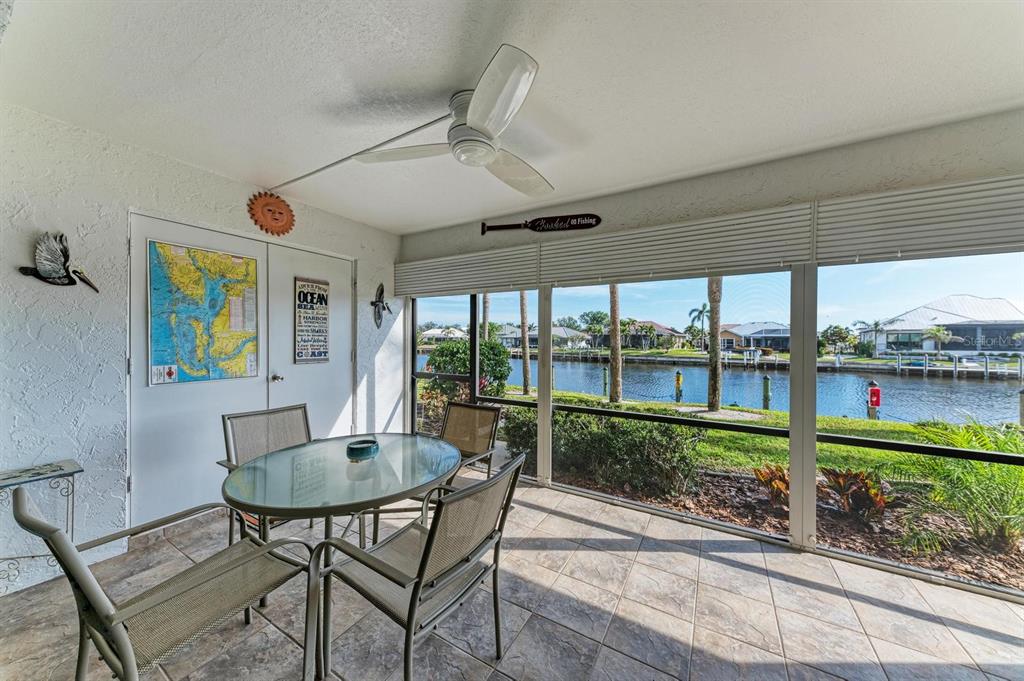 601 Shreve Street, Unit 46A Punta Gorda, FL 33950 - Photo 18 of 23 a dining room with furniture water view and a floor to ceiling window