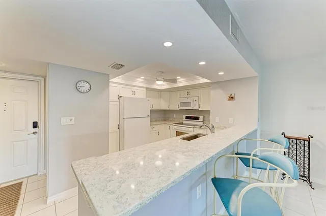 a kitchen with stainless steel appliances kitchen island a sink and cabinets