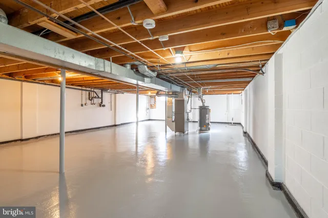 a view of a water heater room with wooden floor