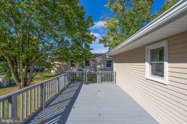 a balcony with wooden floor and fence