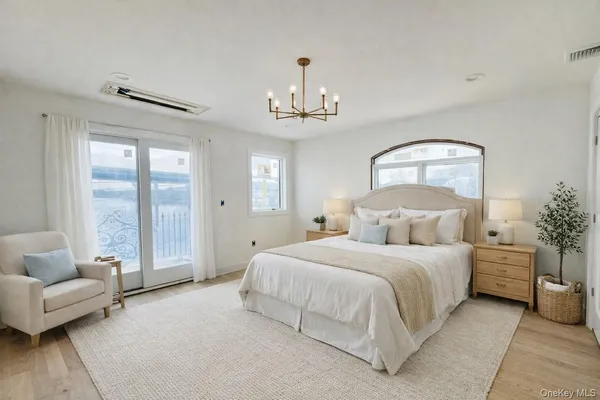 a bedroom with a bed couch and window