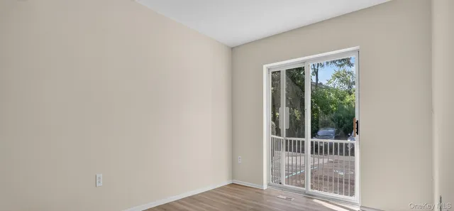 a view of a door and wooden floor