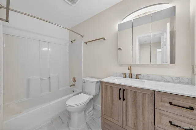 a bathroom with a granite countertop sink toilet a large mirror and shower