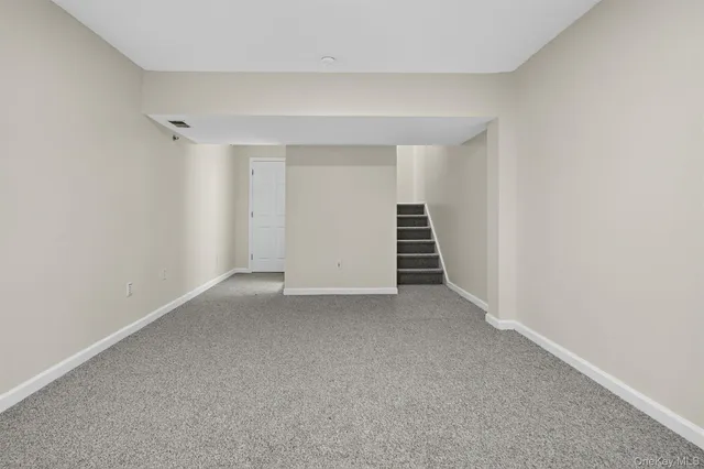 a view of room and hallway with stairs