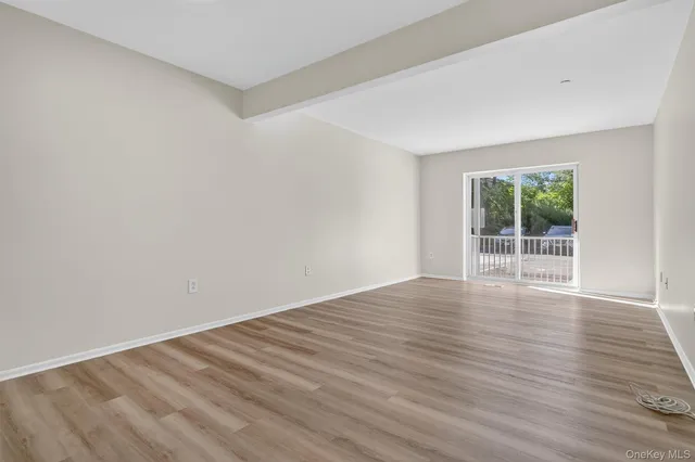 a view of wooden floor and windows in a room