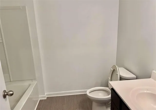 a white toilet sitting next to a bathroom sink
