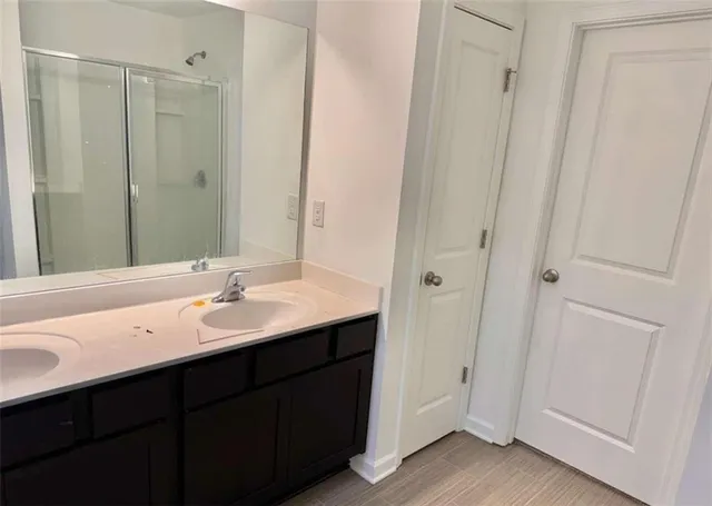 a bathroom with a double vanity sink and mirror
